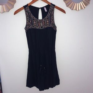 Navy romper with pink, yellow, and white detail